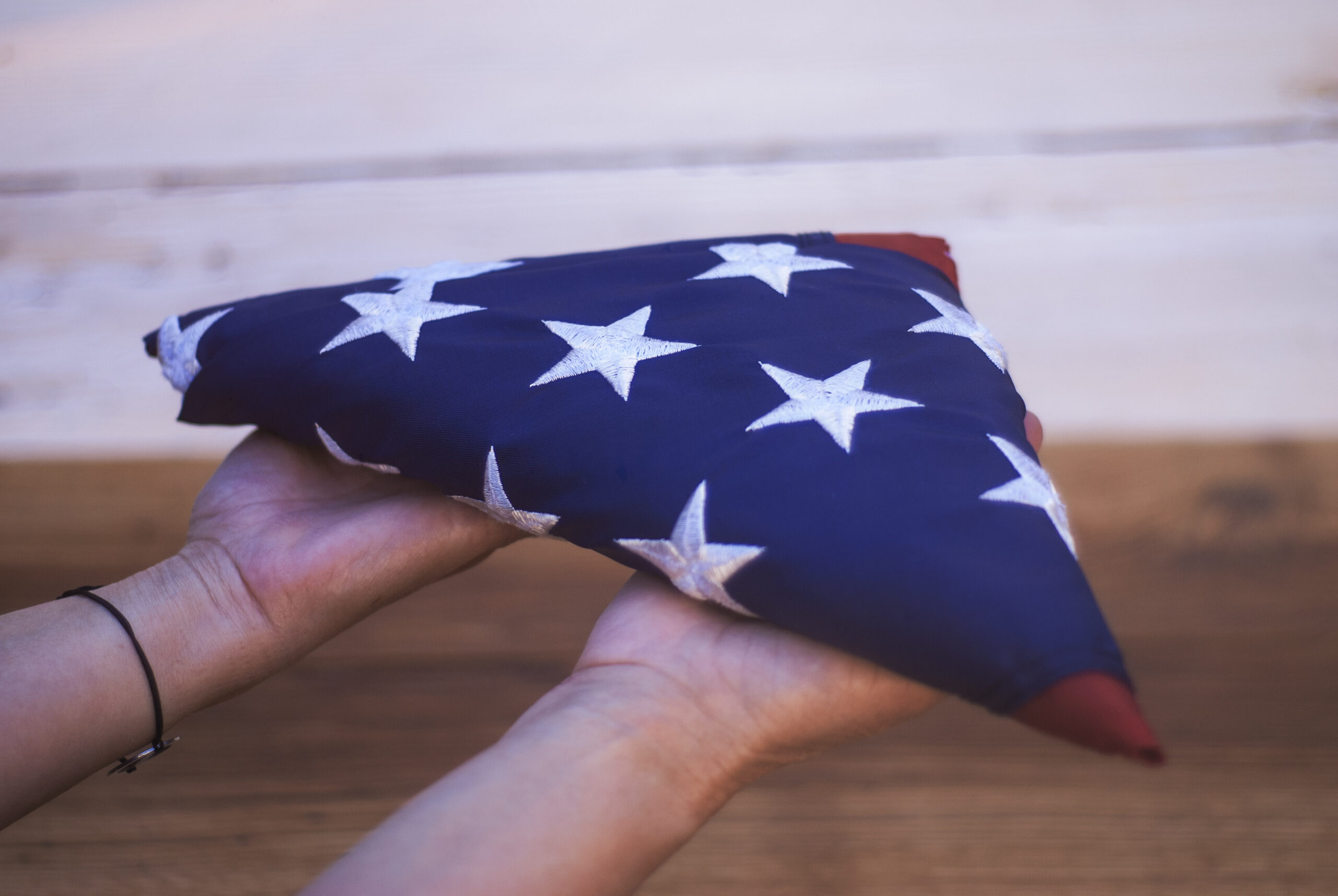 Happy,Memorial,Day.,Girl,Holds,A,Folded,American,Flag,In